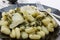 Gnocchi pasta close up with parmesan cheese and pesto