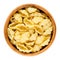 Gnocchi pasta in wooden bowl over white