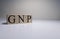 GNP ,Gross National Product, sign on wooden cubes. Clse up.