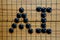 GO - AI abbreviation for Artificial Intelligence Lettering on the famous Asian board game GO in black