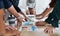 Go getters get hands on. Cropped shot of a group of businesspeople discussing paperwork during a meeting in a modern