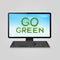 Go green grass inscription on computer monitor - concept of ecoenvironment friendly computer.