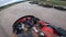 Go Kart racing on a tarmac road driver helmet point of view