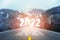 Go to the New Year 2022 concept. Number of the old year written on highway road in the middle of empty asphalt road through the