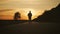 Go to the sunset, the lower angle. Young man walking on a countryside road against the sunset.