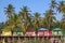 Goa beach Palolem India, colorful bungalows under the palm tree