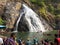 Goa, India - December 6, 2018: Beautiful view of Dudhsagar mountain waterfall. People swim near the waterfall, admire nature and