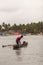 GOA, INDIA - May 14, 2020: Betul,Goa/India- May 16 2020: Local Indian native/farmer watering a coconut sapling plantation. Youn