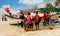 Goa, India - October 24, 2018: Bunch of kids in Soccer player shirt on a beach working with fishing net on a beach against blue