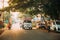 Goa, India. Truck And Scooters Motorcycles Moving On Street In Sunny Summer Day