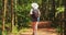 Goa, India. Young Backpacker Tourist Woman Walking And Taking Photos In Tropical Jungle Forest In Sunny Day. Lady