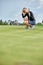 Goal concept, copy space. Women golfing time holding golf equipment on green field background. The pursuit of excellence