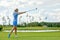 Goal concept, copy space. Women golfing time holding golf equipment on green field background. The pursuit of excellence