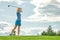 Goal concept, copy space. Women golfing time holding golf equipment on green field background. The pursuit of excellence