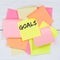 Goal goals to success aspirations and growth business concept desk note paper