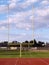 Goal posts empty football field clouds