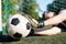 Goalkeeper with ball at football goal on field