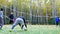 Goalkeeper bounces ball view through gate net in autumn park