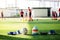 Goalkeeper gloves and football on green artificial turf. Football and soccer training equipment on green artificial turf with