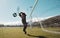 Goalkeeper, soccer and man jumping for the ball to save the goals by the score post at an outdoor field. Fitness