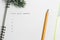 Goals, Notebook and yellow pencil with conifer branch