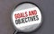 Goals and Objectives word on paper through magnifying lens