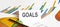 GOALS text on paper on chart background with pen