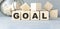 GOALS text on wooden cubes with winning cups