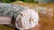 Goat cheese with gray mold is cut with a knife