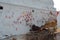 A goat is eating food in a hindu religious place or temple; the hands imprints on the wall