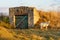 A goat grazes near the village cellar. Background with copy space for text