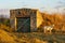 A goat grazes near the village cellar. Background with copy space for text