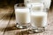 Goat milk in glasses, vintage wooden background, selective focus