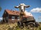 Goat mowing grass with toy lawnmower