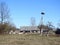 Goat near outhouse and stork birds in village, Lithuania