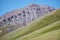 Goats and sheeps graze on mountain steppe pasture slopes in natural mountain boundary Tsagduult in Mongolia