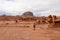 Goblin Valley - Woman hiking next to unique eroded Hoodoo Rock Formations at Goblin Valley State Park in Utah, USA