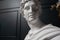 God Apollo bust sculpture. Ancient Greek god of Sun and Poetry Plaster copy of a marble statue  on black.