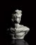 God Apollo bust sculpture. Ancient Greek god of Sun and Poetry statue isolated on black.