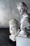 God Apollo bust sculpture and bust of the Farnese Hercules. Head sculpture, plaster copy of a marble statues of Greek gods and