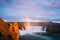 Godafoss waterfall and rainbow on a sunny evening