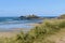 Godrevy Lighthouse, edge of dunes  and beach at low tide Cornwall  UK