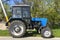 Gogolev, Ukraine, April 2021: -  Old Soviet powerful wheeled  tractor Belarus 82.1 stands on side of road in village. Produced at