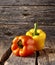 Gogosari peppers, a sweet Romanian ribbed heirloom Capsicum annuum fruit. Whole ripe pods. Bell peppers on wooden background