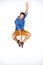 Going crazy. Stylish young guy jumping expressively against a white background.