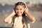 Going with the flow. Adorable headset user. Small child wearing adjustable white headset. Little girl using wireless