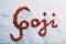 `Goji` word composed of little red goji berries.