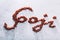 `Goji` word composed of little red goji berries.