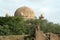 Gol Gumbaz behind foliage