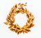 Gold autumn leaves wreath on white background, top view. Fall leaves circle round frame